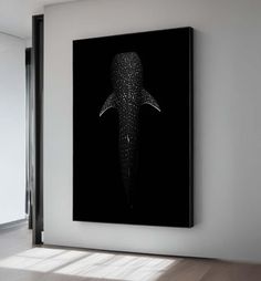 a black and white photo of a whale in the ocean with stars on it's back