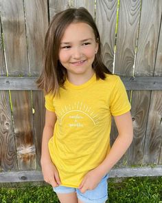 This tee combines 3 of the best things! Sprinkles, sunshine, and a super-soft and cozy fabric. The perfect tee for your little ray of sunshine. Featuring side-seaming, a comfortable crew neck, and a tear-away label. Made of 50% polyester, 25% Airlume combed and ring-spun cotton, 25% rayon jersey. 100% No Sweatshops & Eco-Friendly. Pickup is available at our Tigard studio: 7173 SW Dartmouth St., Tigard, OR 97223. After the order is placed, we will email to schedule a pickup time. Cotton Rainbow Print Crew Neck T-shirt, Fun Yellow Cotton T-shirt, Cheap Playful Yellow T-shirt, Playful Cotton T-shirt With Rainbow Print, Yellow Short Sleeve T-shirt With Text Print, Cozy Fabric, Ray Of Sunshine, Yellow T Shirt, Sunshine Yellow