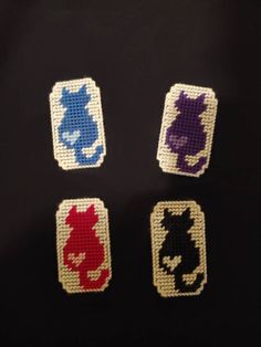 four different colored cats are shown on the back of a black shirt with white and blue squares