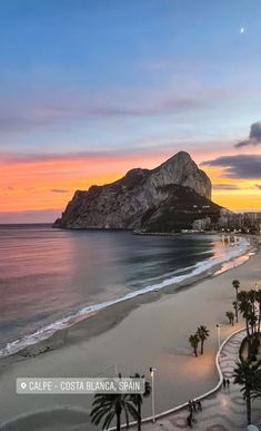 the beach at sunset with palm trees and mountains in the background is seen from above