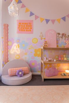 a child's room with pink and yellow decorations on the walls, furniture and decor