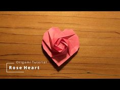 an origami heart sitting on top of a wooden table