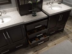 a bathroom with double sinks and two mirrors