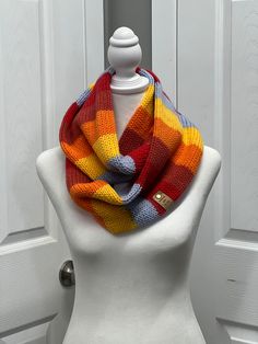 a white mannequin wearing a multicolored scarf