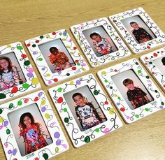 four frames with children's pictures on them sitting on a wooden table next to each other