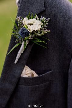 a man in a suit with a boutonniere on his lapel