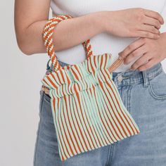 Stripes on stripes on stripes! Fully lined, cheerful knit mini tote with hand-knotted handle. Fits all the essentials in an easy drawstring shape. Details Body: 100% AcrylicLining: 100% Cotton Hand wash cold, dry flat9.5"W, 9.5"L, 3.75" strap drop Casual Striped Woven Bag, Casual Striped Bags With Braided Handles, Casual Macrame Bag For Spring, Casual Macrame Crochet Bag For Spring, Casual Crochet Macrame Bag For Spring, Casual Spring Macrame Crochet Bag, Casual Spring Crochet Macrame Bag, Spring Cotton Crochet Woven Bag, Casual Cotton Crochet Bag With Braided Handles