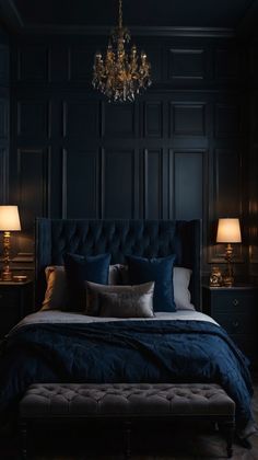 a bedroom with dark blue walls and a chandelier hanging from the ceiling above the bed