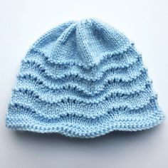 a blue knitted hat on a white background