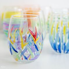 several colorful glass cups sitting next to each other