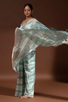 Mint blue handloom banarasi saree with stripe pattern. Comes along with unstitched blouse piece. - Aza Fashions Transitional Blue Cotton Silk Pre-draped Saree, Blue Tissue Silk Blouse Piece For Transitional Season, Blue Slub Silk Pre-draped Saree With Self Design, Blue Cotton Silk Pre-draped Saree, Blue Handloom Tissue Silk Blouse Piece, Sarees Banarasi, Blue Saree, Banarasi Saree, Mint Blue