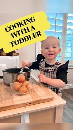 a little boy that is standing in front of a table with some food on it