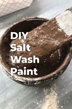 a wooden spoon filled with chocolate paint and the words diy salt wash paint over it