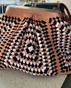 a crocheted purse sitting on top of a table