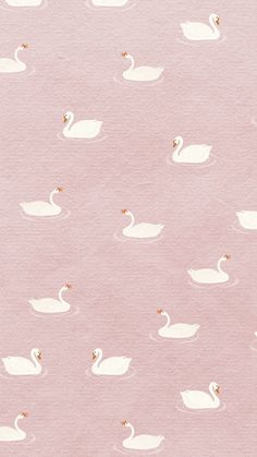 a watercolor painting of swans swimming in the water on a pink background with gold accents