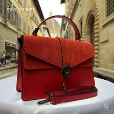 This bag has been made of the best genuine leather by local master crafters of Florence in Italy, designed for women who only accept premium Italian quality and luxury leather bags and modern Italian fashion. . Sizes: Width: 29cm/10.6 inch Height: 19cm/7.4 inch Depth: 7 cm/3.9 inch color: Red . The story of this bag: Once upon a time, in the heart of Florence, there was a small workshop where skilled artisans crafted elegant leather bags for women. The workshop was famous for its red leather bag Luxury Handmade Red Bags, Modern Red Satchel Flap Bag, Red Leather Business Briefcase, Modern Red Flap Bag For Daily Use, Leather Flap Bag With Smooth Grain For Daily Use, Formal Red Shoulder Bag With Smooth Grain, Daily Use Leather Flap Bag With Smooth Grain, Formal Red Smooth Grain Shoulder Bag, Red Luxury Satchel With Leather Handles