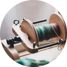 a spool of thread sits on top of a spinning machine