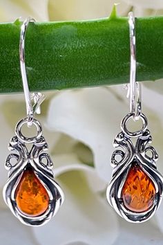 * 100% Natural Baltic Amber, 925 Sterling Silver.  * Earring Total Length: 35 mm (1.37"), Width: 10 mm (0.39"). * Stones size: 10 mm x 6 mm  (0.39" x 0.23"). * Total Weight: 2.9 gram. * Color: Brown. * These Earrings are for adults only. Natural Amber Teardrop Earrings. Did you know that Amber was one of the first materials ever used for accessorizing? Ornaments made out of amber were found on prehistoric people dating all the way back to the Stone Age, which was over 10,000 years ago! Throughou Classic Amber Sterling Silver Earrings, Elegant Amber Sterling Silver Earrings, Classic Amber Earrings For Gift, Orange Drop Earrings For Anniversary, Amber Dangle Earrings For Anniversary, Orange Teardrop Sterling Silver Earrings, Elegant Nickel-free Orange Earrings, Elegant Orange Sterling Silver Earrings, Elegant Orange Nickel-free Earrings