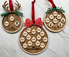 three wooden ornaments with red bows on them