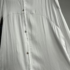 Indulge in luxury with our Italian silky shirt dress. This exquisite dress is made in Italy and features a soft, silky fabric that will drape elegantly on your body. The button-down design adds a touch of sophistication, while the two pockets provide convenience. One size fits most for a comfortable and stylish fit. Elegant Collared Rayon Dress, Silk Button-up Shirt Dress For Daywear, Elegant Rayon Shirt Dress For Daywear, Chic Button-up Silk Shirt Dress, Elegant Midi Length Rayon Shirt Dress, Elegant Long Rayon Dresses, Elegant Viscose Button-up Shirt Dress, Elegant Rayon Shirt Dress For Summer, Elegant Button-up Viscose Midi Dress