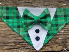 a green and white bow tie with black buttons