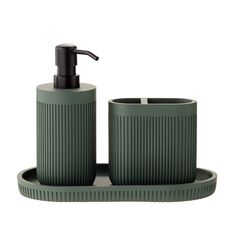 a green soap dispenser and two cups