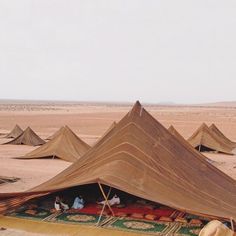 a group of tents in the middle of desert