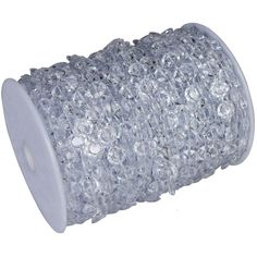 a spool of clear crystal beads on a white background