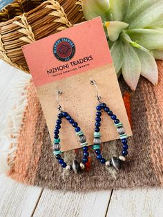 New without tags BRAND : Nizhoni Traders LLC JEWELRY TYPE : Earrings TYPE : Earrings STYLE : Dangle METAL : Sterling Silver MAIN STONE : Lapis Lovely Handmade Turquoise, Lapis and Sterling Silver Beaded Dangle Hoop Earrings. Such beautiful craftsmanship! These measure 2 1/4 inches long and 1 inch wide. Stones are natural and will vary. Thank you for checking out my store. Please contact us with any questions. 4/25/23 bin 28 Traditional Earrings With Round Natural Stones, Traditional Earrings With Natural Stones, Artisan Blue Earrings With Dangling Beads, Blue Bohemian Hoop Earrings With Natural Stones, Bohemian Blue Hoop Earrings With Natural Stones, Bohemian Blue Beaded Earrings With Natural Stones, Southwestern Style Earrings With Dangling Round Beads, Artisan Natural Stone Beaded Dangle Earrings, Artisan Dangle Beaded Earrings With Natural Stones