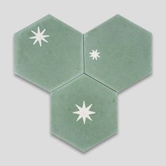 three green hexagonal tiles with white stars on the top and bottom one is light green