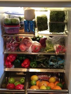 an open refrigerator filled with fruits and vegetables