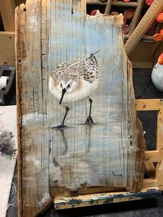 a piece of wood with a bird painted on it