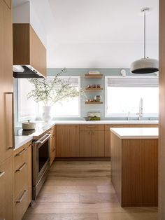 a kitchen with wooden cabinets and white counter tops