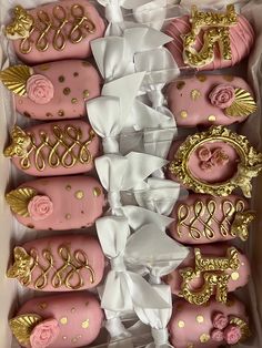 pink and gold decorated cookies in a box