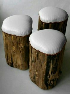 three wooden stools covered in snow sitting next to each other