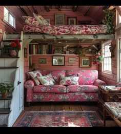 a living room with pink couches and bookshelves