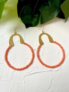 Handmade hoop earrings with tangerine orange seed beads and brass hammered earring findings.  Lightweight earrings. Made with nickel free earring hook. Measure approximately 3.5 inches long. Handmade Hoop Earrings, Hammered Earrings, Earring Hook, Nickel Free Earrings, Tangerine Orange, Lightweight Earrings, Earring Findings, Light Weight Earrings, Wedding Shop