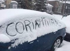 a car covered in snow with the word corona written on it