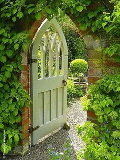 an open white door surrounded by greenery