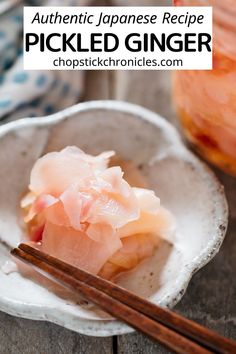 a white bowl filled with pickled ginger next to chopsticks