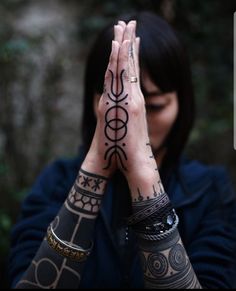 a woman with tattoos covering her face and hands