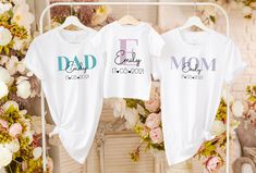 "Create unforgettable memories with our personalized family matching outfit set. Our collection includes comfortable and stylish adult white t-shirts and cute baby bodysuits, all designed to celebrate the bond within your family. Each item of clothing can be matched with the Your child's name and date of birth can be personalized, adding a special touch that captures the uniqueness of your little one. Crafted with care, our family matching outfits are made from high quality, soft fabrics that pr White Family Matching Sets With Letter Print, White Cotton Matching Outfits Set, White Cotton Matching Outfit Sets, Matching White Tops For Family Events, White Cotton Gift Sets, Personalized White Family Matching Tops, White Top For Mother's Day Family Events, Customizable White Gift Sets, White Matching Set Tops