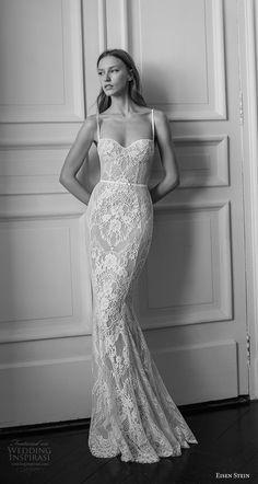 black and white photograph of a woman in a wedding dress leaning against a wall with her hands on her hips