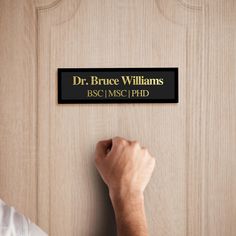 a person is holding up a plaque that says dr bruce williams