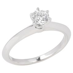 a white gold engagement ring with a single diamond