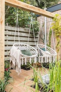 a white hammock hanging from a wooden frame