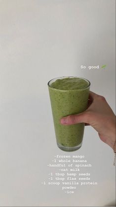 a hand holding a glass filled with green smoothie and the words so good above it