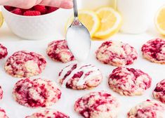 raspberry lemon cookies are being drizzled with icing