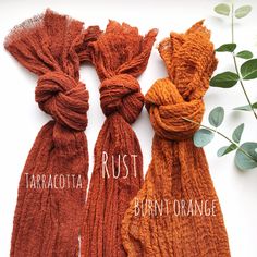 three scarves with the names tararootata rust, burnt orange and tarracotta rust