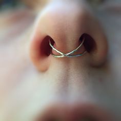 a close up view of a nose with a ring on it